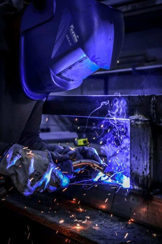 Welder fabricating a steel frame